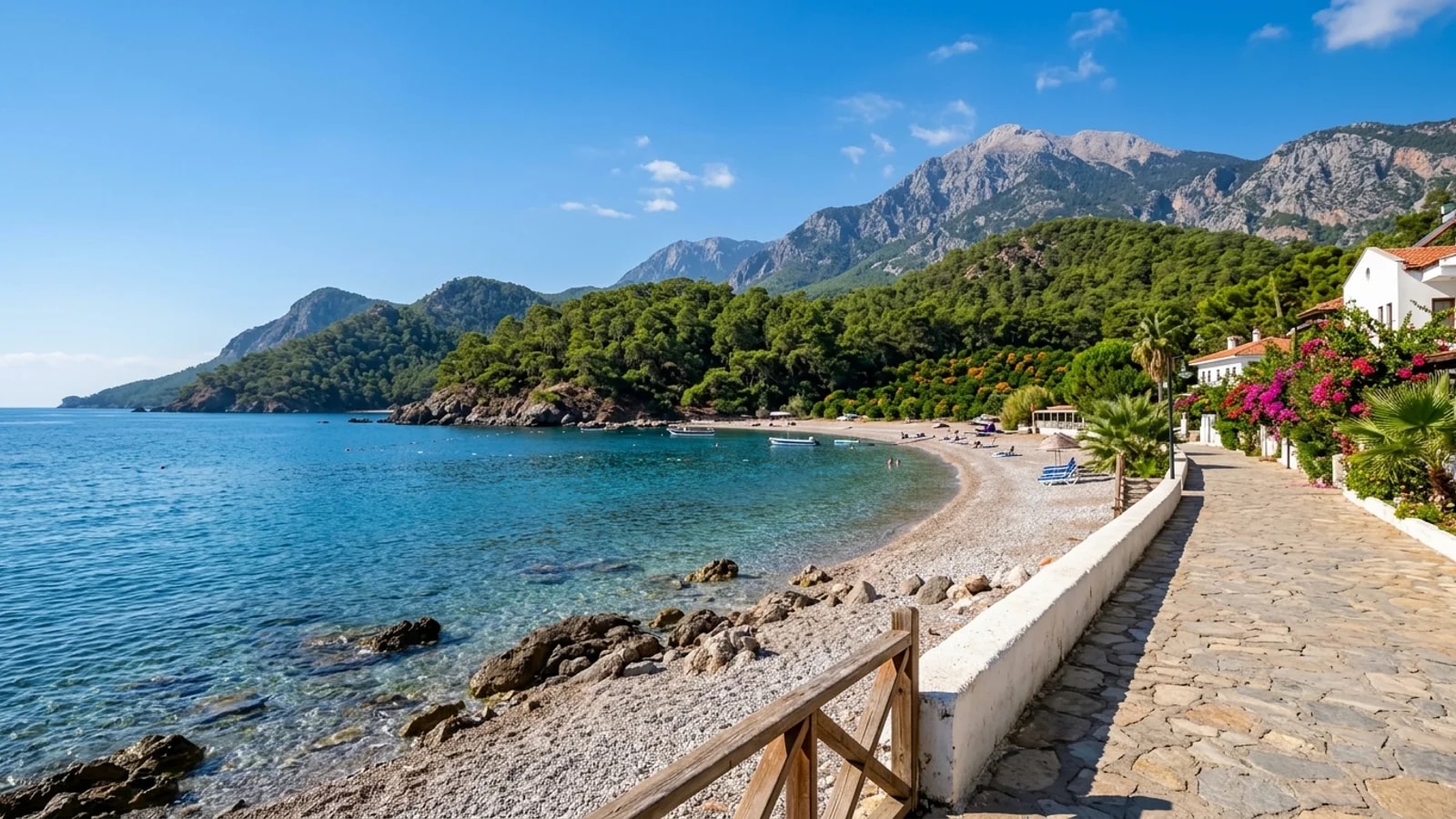 Beautiful pebble cove in Çamyuva A pebble cove in Çamyuva with calm clear water, orange groves, pine woods and distant mountains.