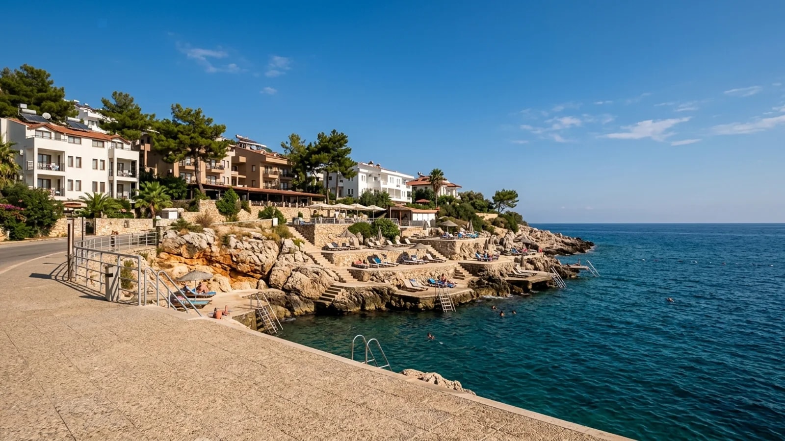 Coastal resort in Payallar A small resort in Payallar features coastal hotels, stepped sunbathing platforms and ladders into deep blue water.