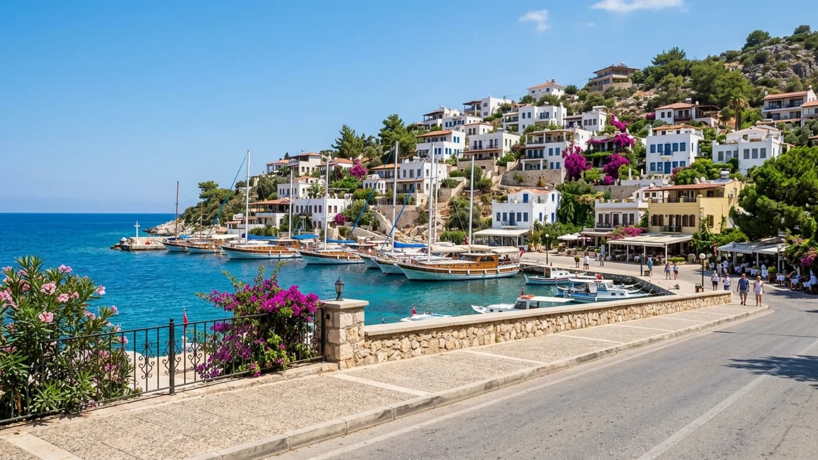 Scenic Kalkan harbour holiday destination White houses with blue shutters on a steep slope above the turquoise water of Kalkan harbour.