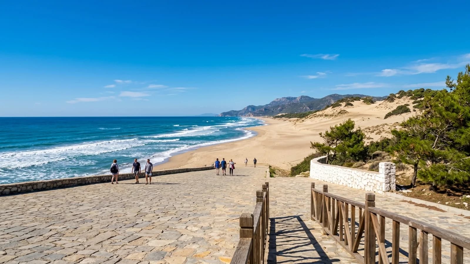 The vast sandy beach of Patara Waves roll onto the long sandy beach at Patara, backed by huge dunes under clear skies.